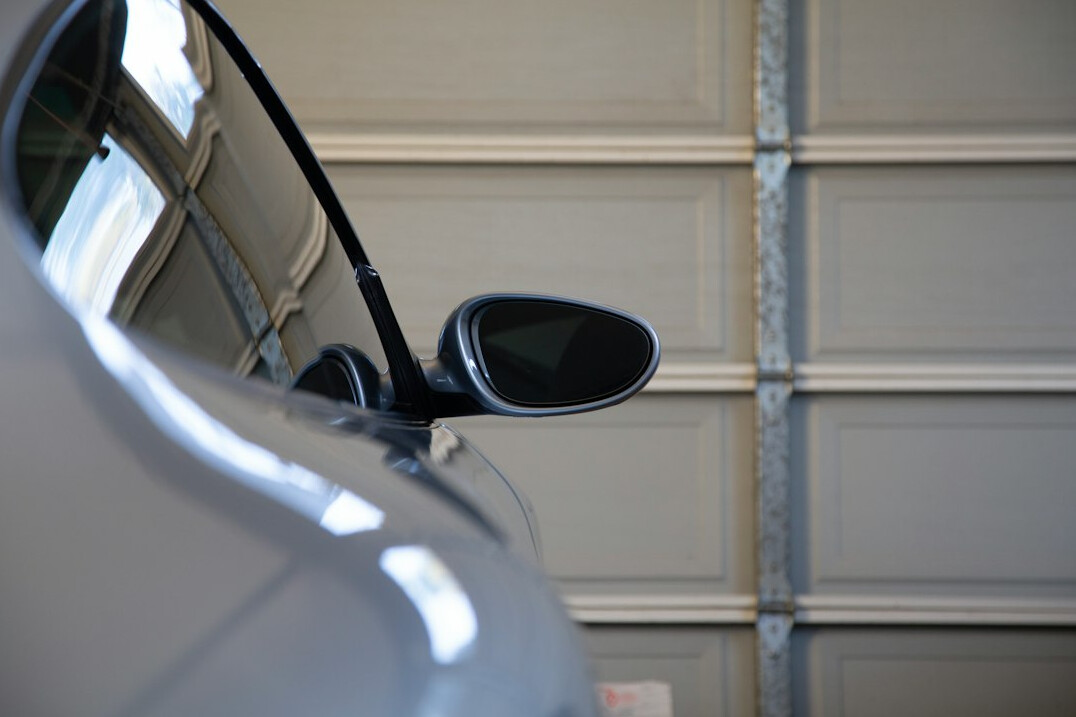 Car with door open in a garage